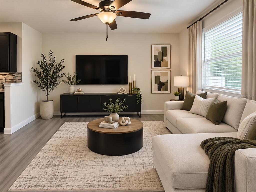 A kitchen features dark cabinets, granite countertops, a central island, and stainless steel appliances — 2749 PLEASANT CYPRESS CIRCLE, KISSIMMEE, FL