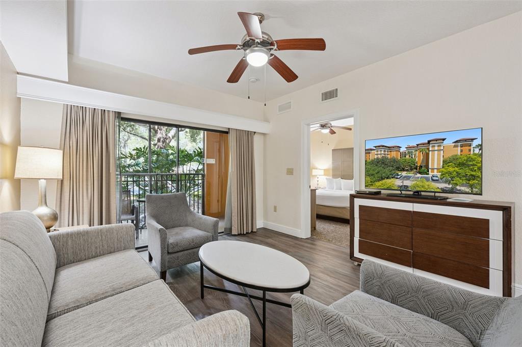 A living room features a sofa, two armchairs, a coffee table, and a television — 12539 FLORIDAYS RESORT DRIVE UNIT 102D, ORLANDO, FL