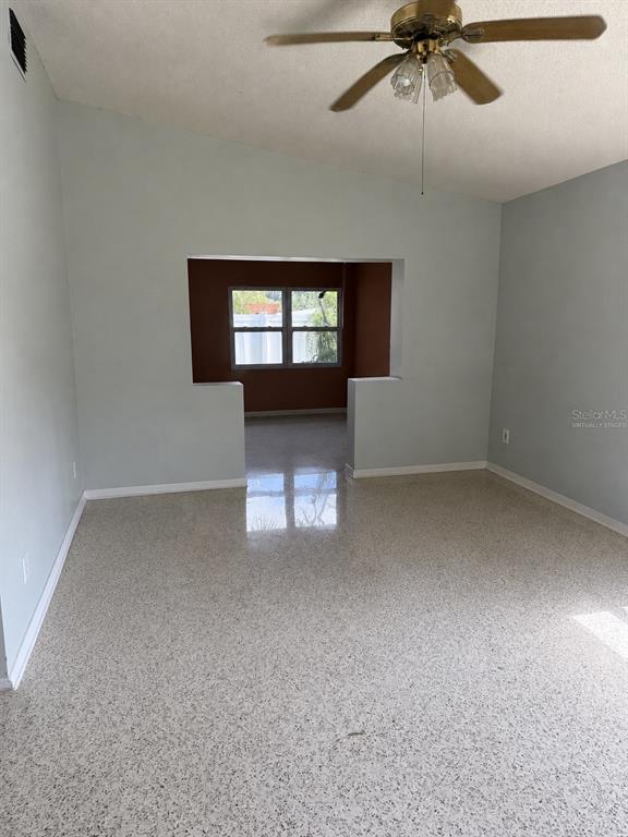 A covered entryway features a concrete patio, a wooden support post, and a glass-paneled door — 2843 BAY STREET, SARASOTA, FL