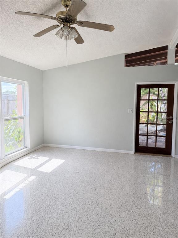A dining area features a stained-glass pendant light, light gray walls, and speckled terrazzo flooring — 2843 BAY STREET, SARASOTA, FL