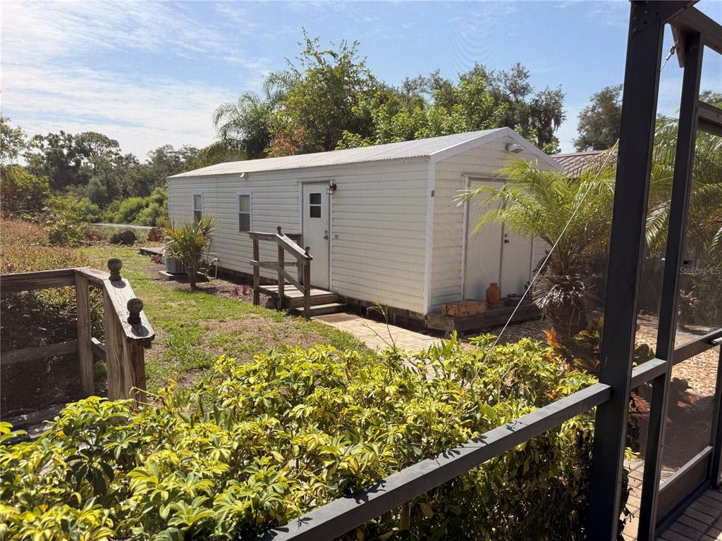 A single-story house with a carport sits on a large grassy lot with mature trees — 6510 SUNRIDGE DRIVE, RIVERVIEW, FL