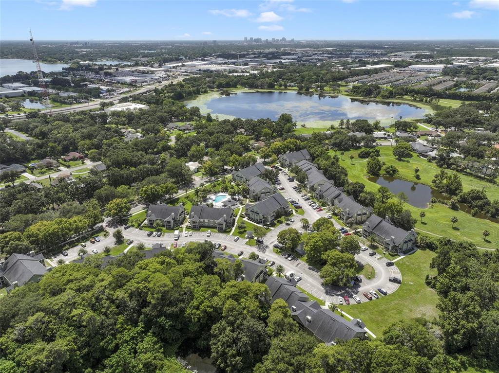 An aerial view shows a multi-building apartment complex surrounded by trees, ponds, and parking lots — 3719 S LAKE ORLANDO PARKWAY UNIT 2, ORLANDO, FL