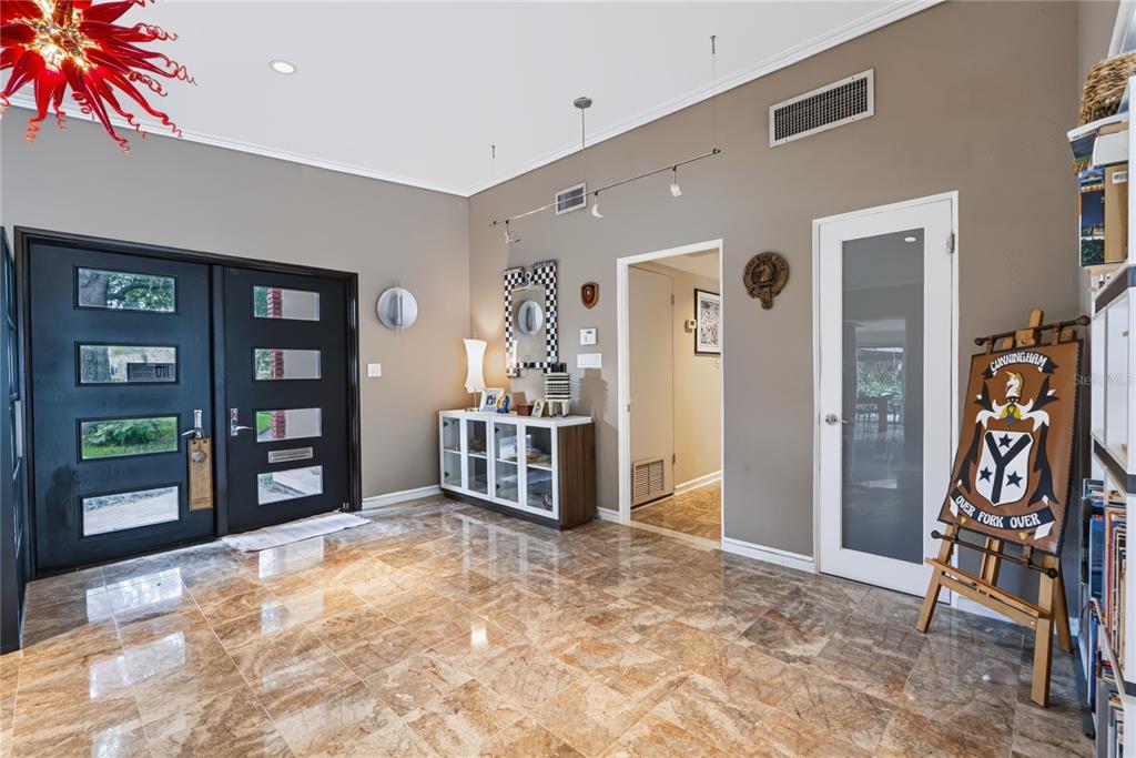 A foyer with marble floors, a double front door, and a coat of arms display — 600 MAYFAIR CIRCLE, ORLANDO, FL