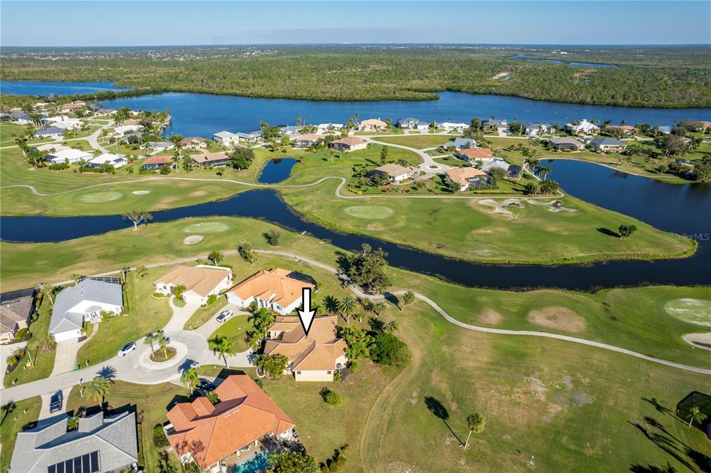 An aerial view shows a residential house with a tile roof on a golf course — 13 SEAWARD CIRCLE, PLACIDA, FL