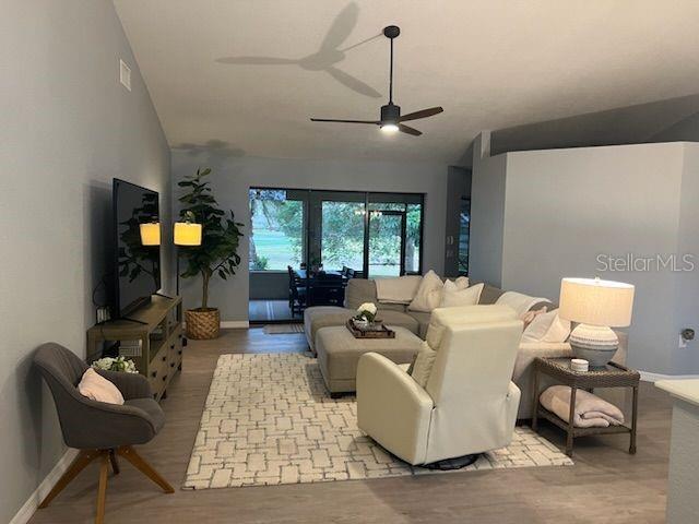 A living room features a gray sofa, a white recliner, and a television on a console — 13 SEAWARD CIRCLE, PLACIDA, FL