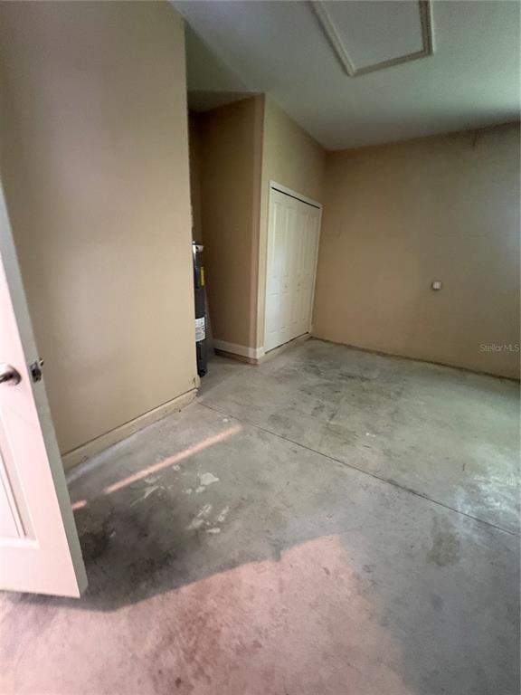 A room with wood-look tile flooring, a tall white cabinet, and an arched window — 20 ETON LANE UNIT A & B, PALM COAST, FL