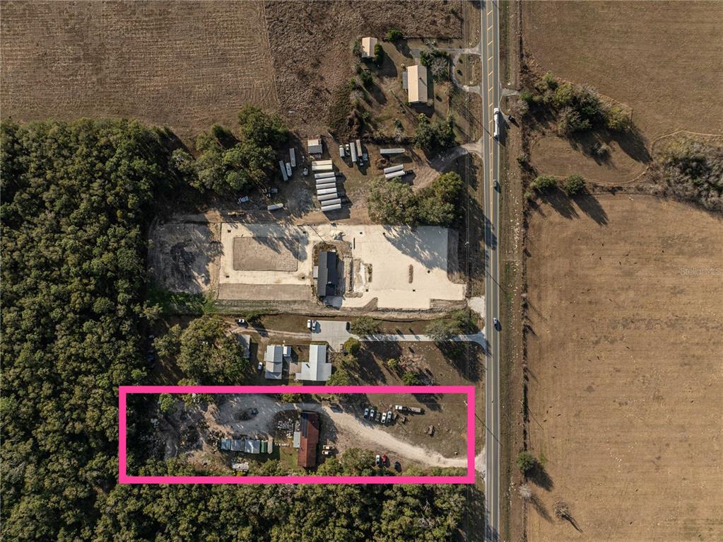 An aerial view shows a rural property with a highlighted rectangular lot containing several structures — 1859 E C 470, SUMTERVILLE, FL