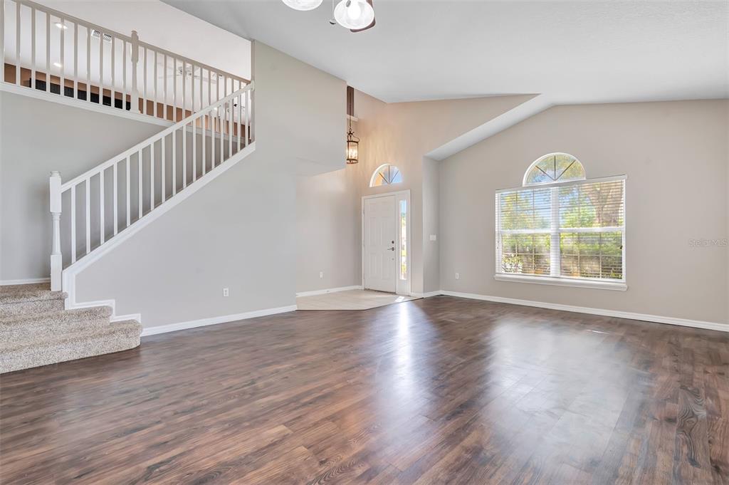 A two-story tan house with a two-car garage and a large tree in the yard — 469 CAREY WAY, ORLANDO, FL