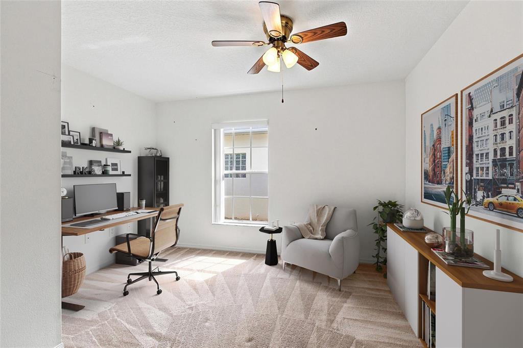 A home office with a desk, chair, armchair, ceiling fan, and wall-mounted shelves — 347 ROYAL PALM DR, DAVENPORT, FL