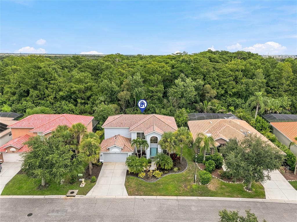 An aerial view of a two-story suburban house with a tiled roof and landscaped front yard — 227 HERITAGE ISLES WAY, BRADENTON, FL