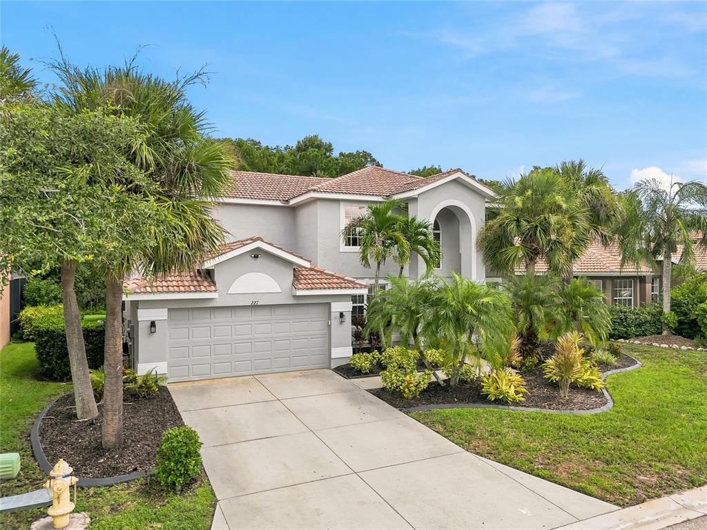 A two-story house with a gray exterior, tile roof, and a two-car garage — 227 HERITAGE ISLES WAY, BRADENTON, FL