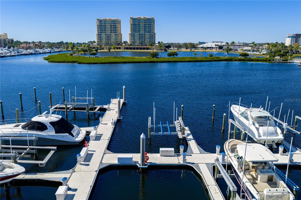 An elevated view of a marina with several docked boats and two high-rise buildings — 313 10TH AVENUE E, PALMETTO, FL