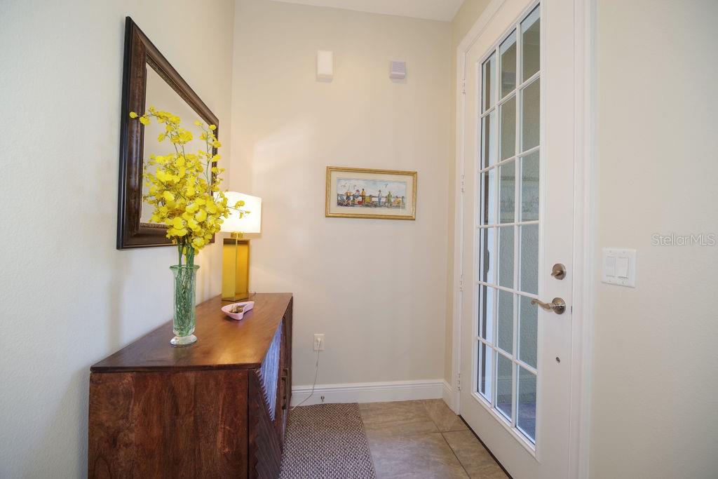 A gated entrance with a brick driveway and a sign for The Greens at Town Villa — 1541 CORKERY COURT UNIT 1541, WINTER SPRINGS, FL