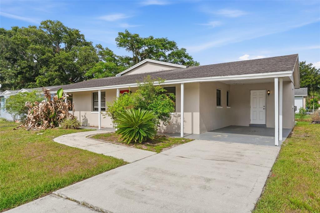 A single-story house with a beige exterior, a concrete driveway, and a covered carport — 2131 MESSINA AVENUE, ORLANDO, FL