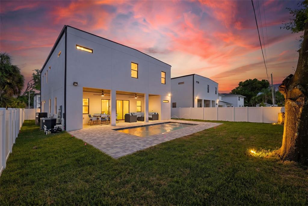A modern two-story white house features a black garage door and a paved driveway — 2308 1/2 N ELCOE DRIVE, TAMPA, FL