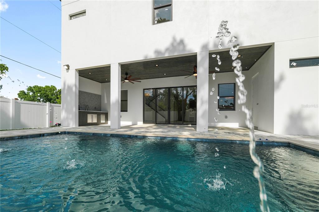 The rear exterior of a modern two-story house features a covered patio and swimming pool — 2308 1/2 N ELCOE DRIVE, TAMPA, FL