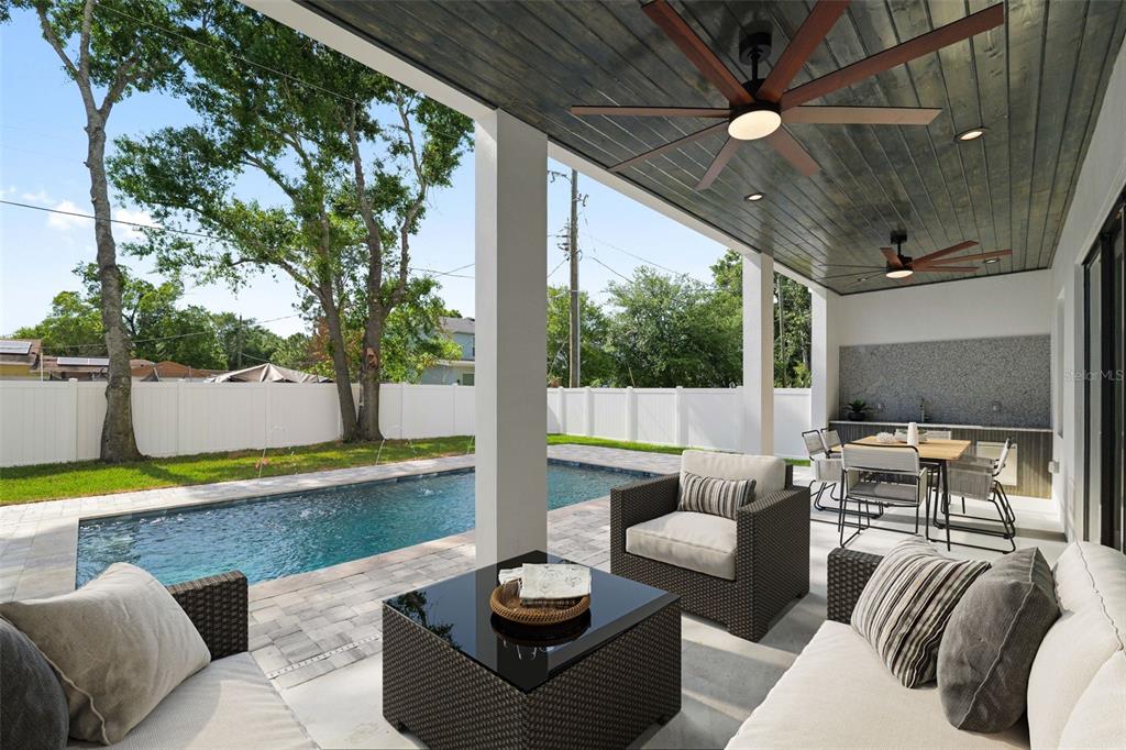 A modern white house features a covered patio with an outdoor kitchen and a pool — 2308 1/2 N ELCOE DRIVE, TAMPA, FL
