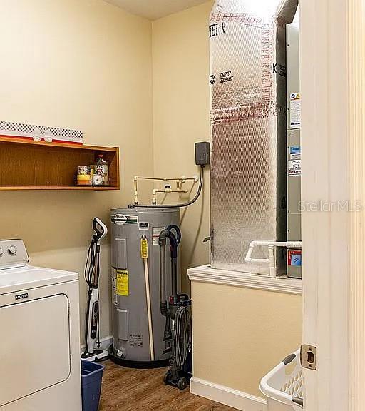 A laundry room contains a white washing machine, a water heater, and an HVAC unit — 1677 W HIGHWAY 316, CITRA, FL