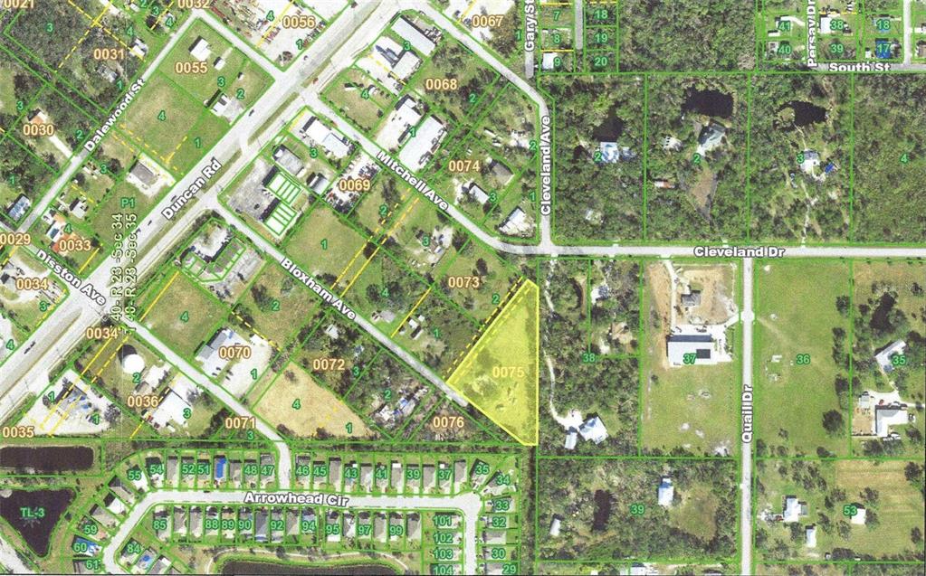 This is an aerial map showing a highlighted parcel of land in a residential area — 830 BLOXHAM AVENUE, PUNTA GORDA, FL