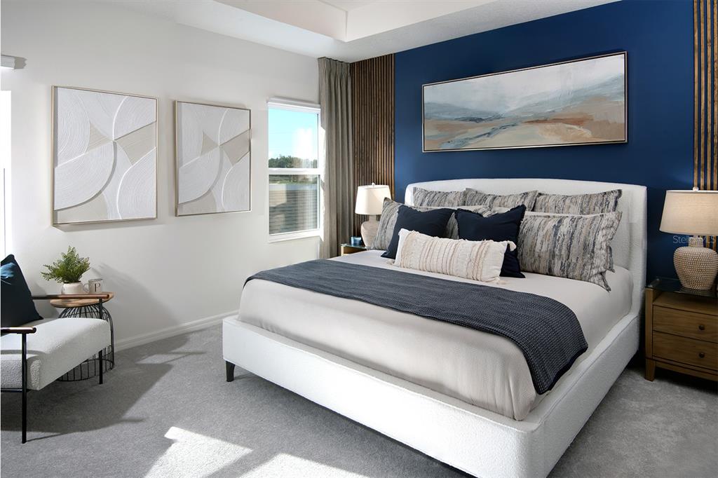 A bedroom features a blue accent wall with wood slats, a white bed, and artwork — 1536 SILVER LINING WAY, APOPKA, FL