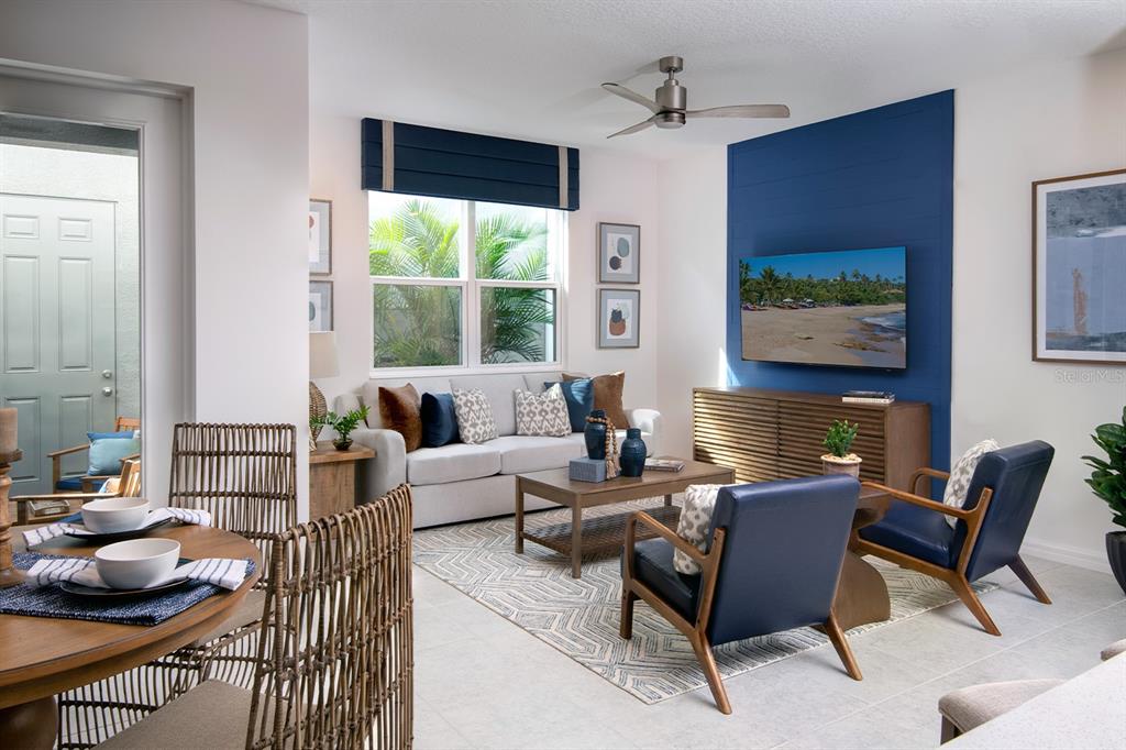 A living room features a blue accent wall, a gray sofa, and two navy armchairs — 1536 SILVER LINING WAY, APOPKA, FL