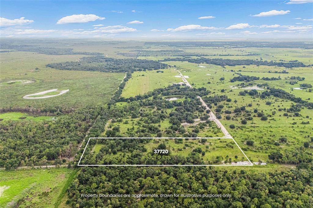 An aerial view shows a rectangular plot of land outlined in white amidst rural vegetation — 37720 KVILLE ROAD, MYAKKA CITY, FL