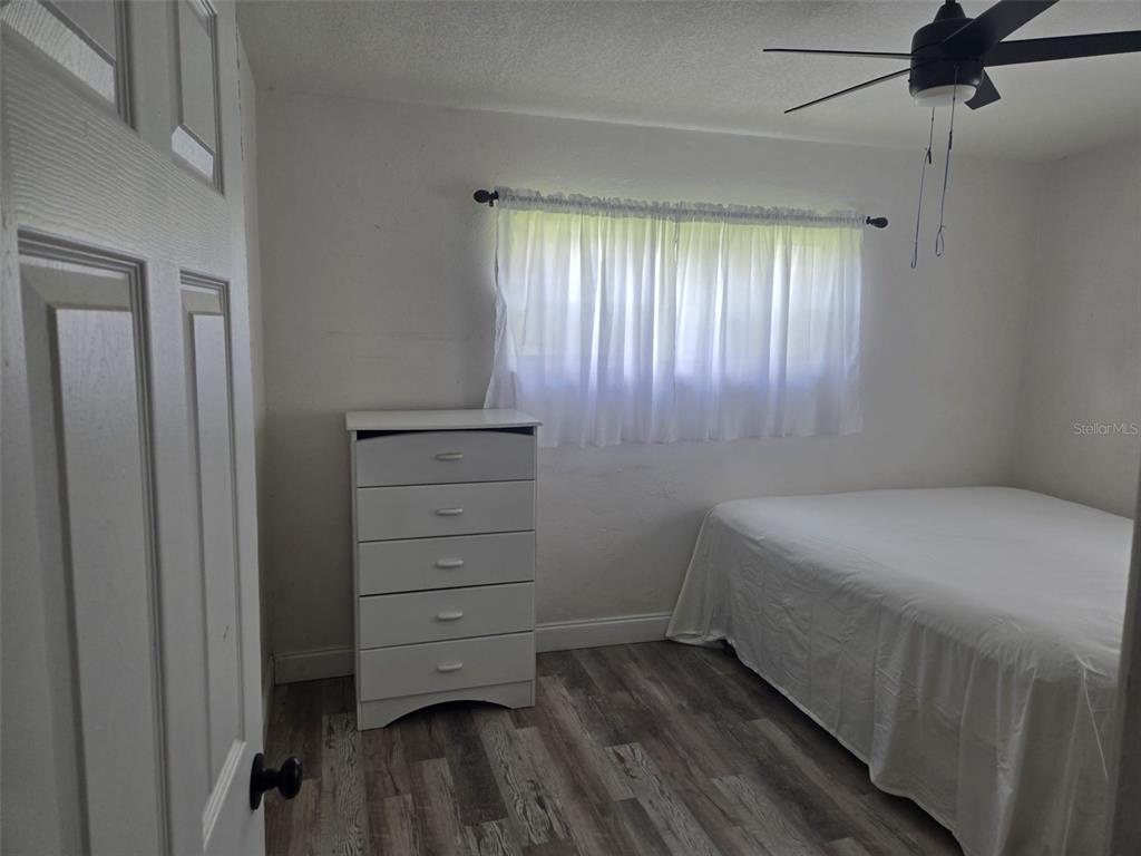 A bathroom features a floral shower curtain, a white toilet, and a grey vanity cabinet — 4810 DEAUVILLE DRIVE, ORLANDO, FL