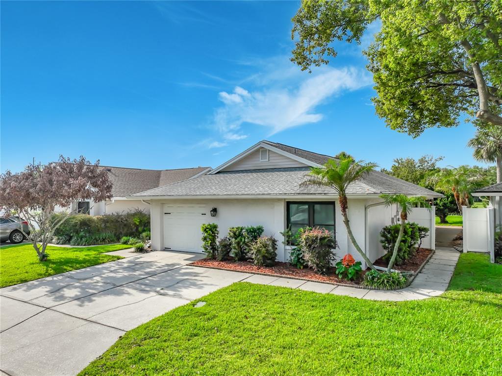 A single-story house with a white exterior, a one-car garage, and a landscaped front yard — 6328 GREENGATE DRIVE, ORLANDO, FL