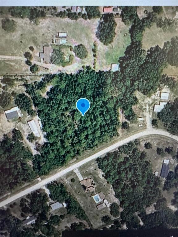 An aerial view of a wooded lot marked with a blue location pin — 00 SW 47TH PLACE ROAD LOT 6, OCALA, FL