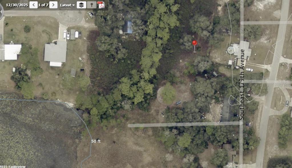 This is an aerial map view of a wooded residential lot near a lake — 2650 SE 179TH AVENUE, SILVER SPRINGS, FL
