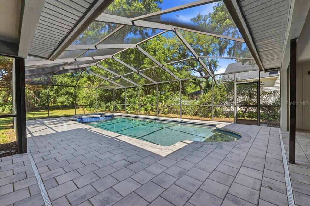 A single-story house with a two-car garage, a large front lawn, and mature trees — 2800 HAMMOCK DRIVE, PLANT CITY, FL