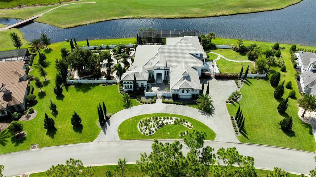 An aerial view shows a large house with a circular driveway and a backyard pool — 1025 SUDBURY LANE, ORMOND BEACH, FL