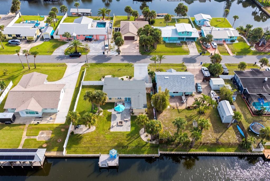 A single-story house with a white garage, blue front door, and a gravel front yard — 119 N PALMETTO AVENUE, FLAGLER BEACH, FL