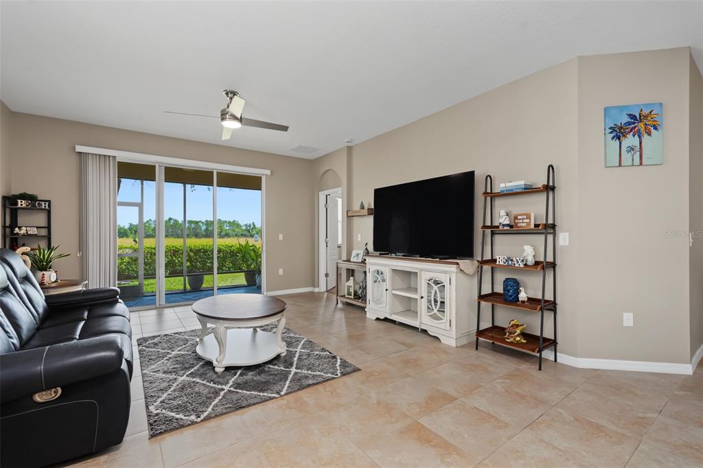 A single-story house with a two-car garage, a concrete driveway, and a palm tree — 33067 WINDELSTRAW DRIVE, WESLEY CHAPEL, FL