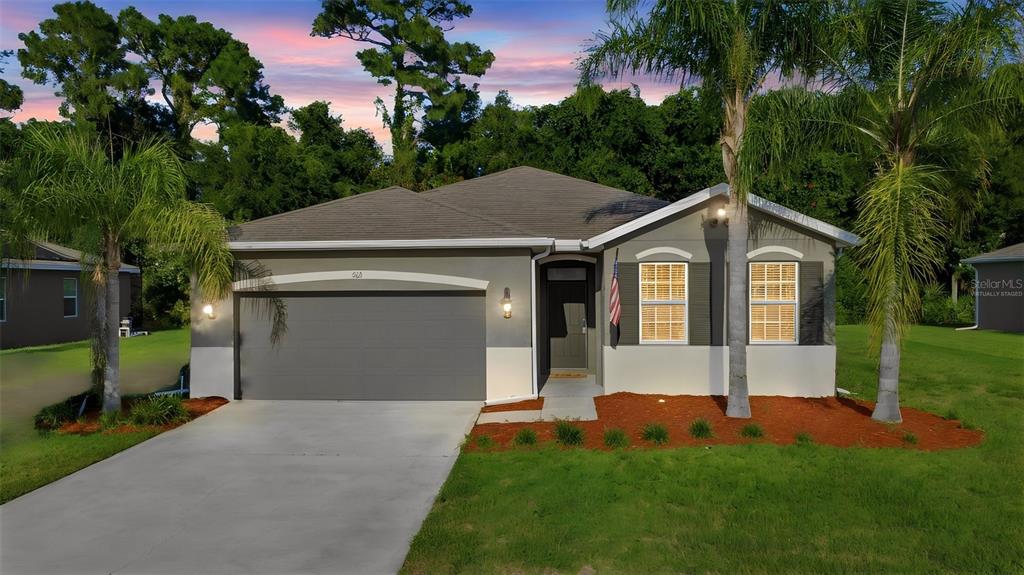 An aerial view shows several suburban houses with driveways and lawns bordering a dense forest — 463 RIVER SQUARE LANE, ORMOND BEACH, FL