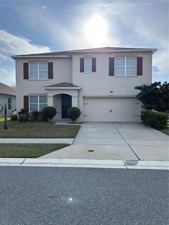 An entryway with tile flooring leads into a carpeted living area with a large window — 281 ST GEORGES CIRCLE, EAGLE LAKE, FL