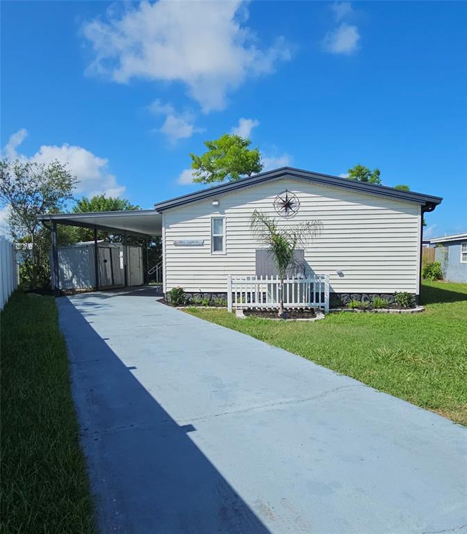 An aerial view shows waterfront homes with docks, lush vegetation, and a canal in Florida — 13147 CABIN COURT, HUDSON, FL