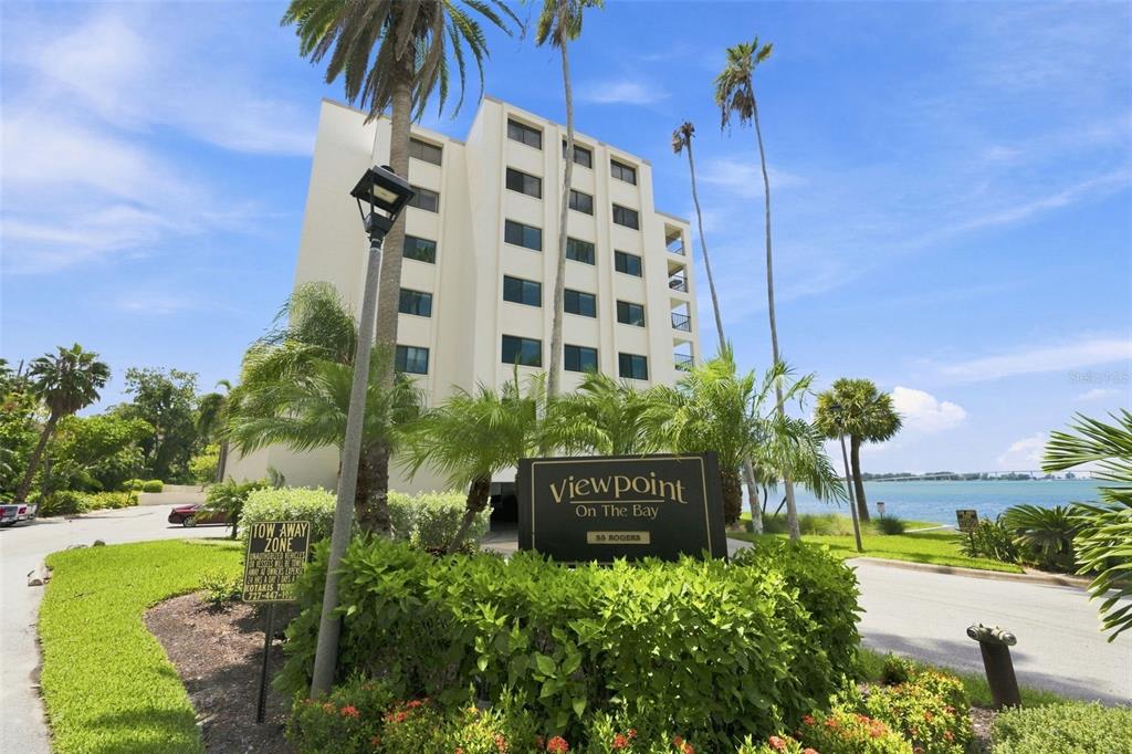 A multi-story residential building stands behind a sign for Viewpoint On The Bay — 55 ROGERS STREET UNIT 204, CLEARWATER, FL